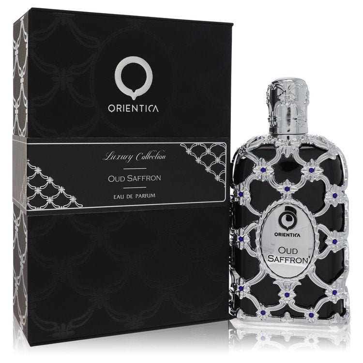 A dark glass bottle of Al Haramain Orientica Oud Saffron Eau De Parfum Spray 5 oz with gold accents on a wooden table by The
