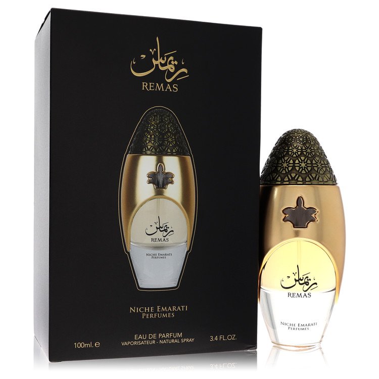 A clear glass bottle with gold accents and a minimalist label, featuring the text Lattafa Niche Emarati Remas, standing on a