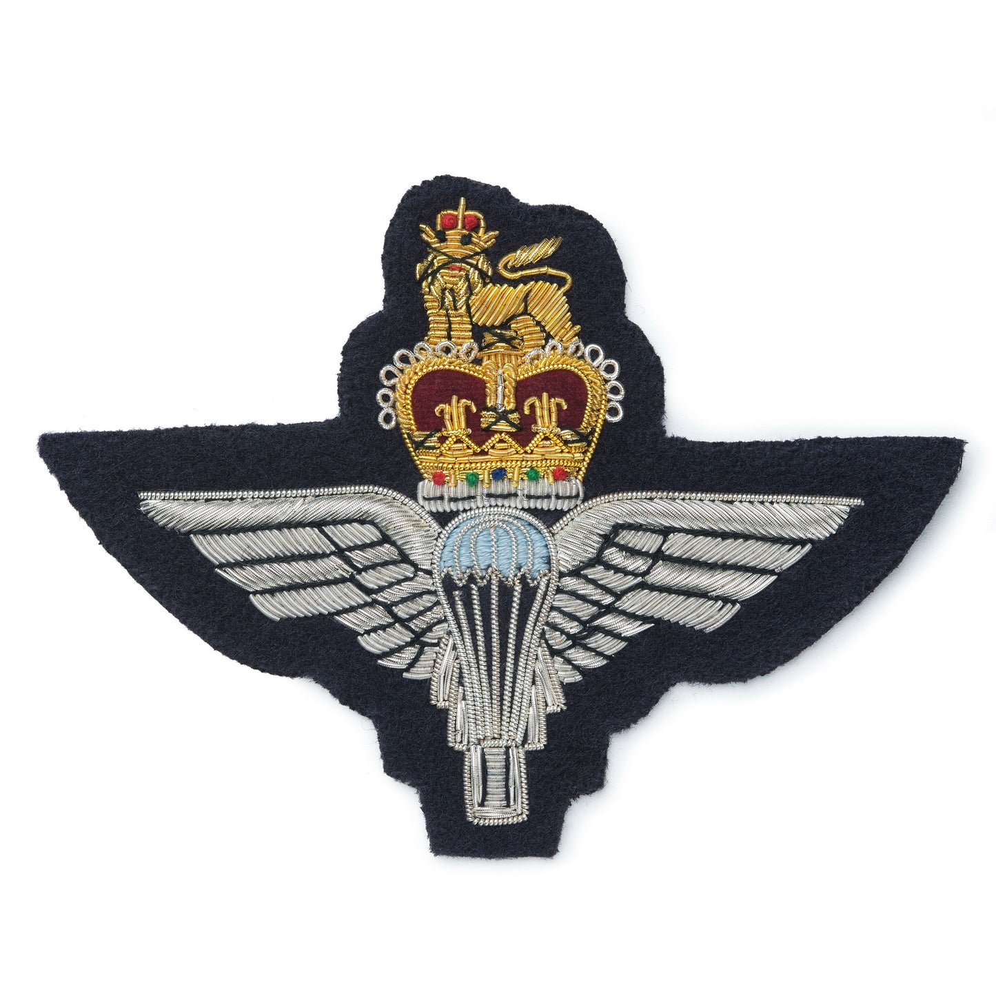 A brass blazer badge featuring the Parachute Regiment emblem, mounted on a dark blue background, by Benson & Clegg.