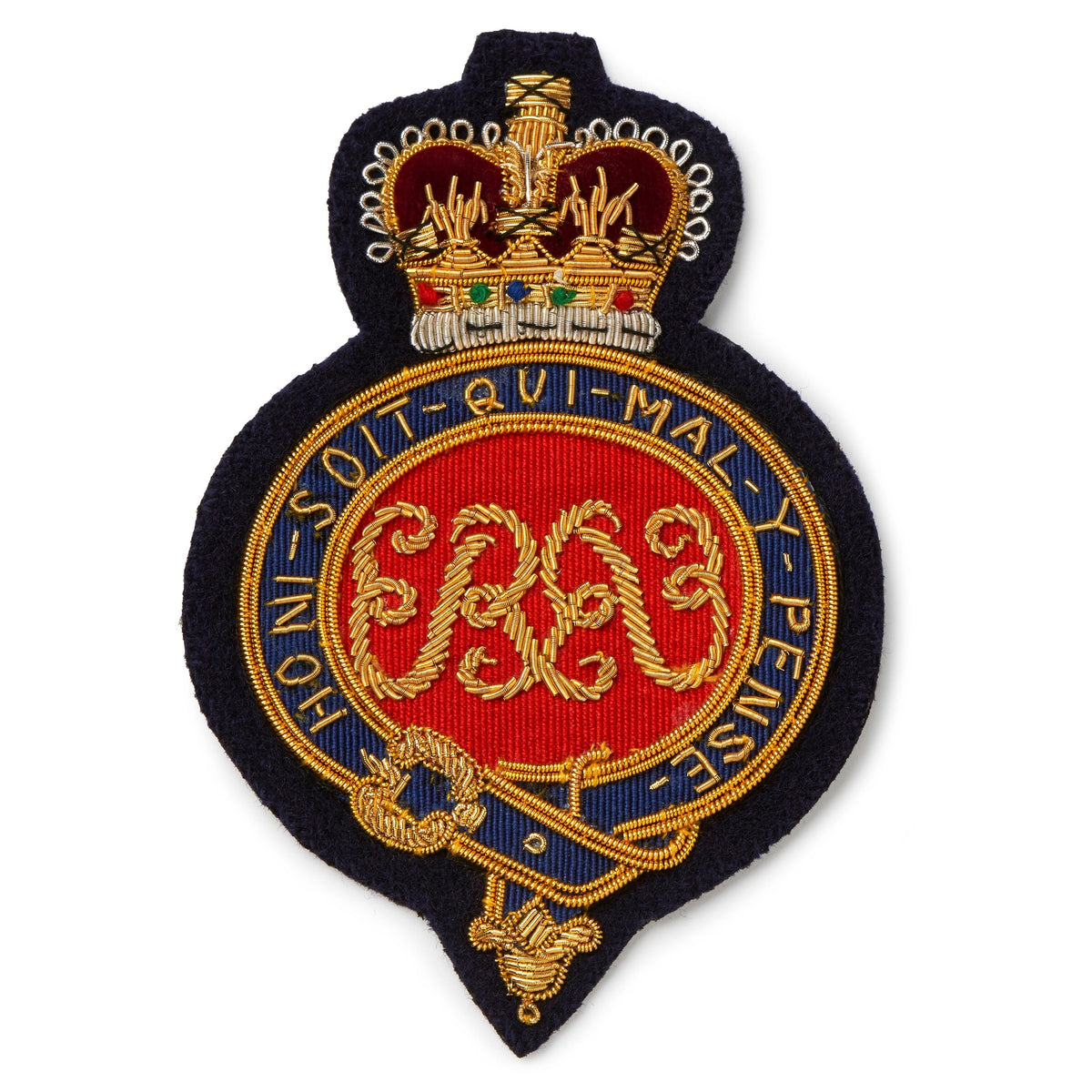 A brass Grenadier Guards Blazer Badge with detailed engraving, mounted on a dark blue background, by Benson & Clegg.