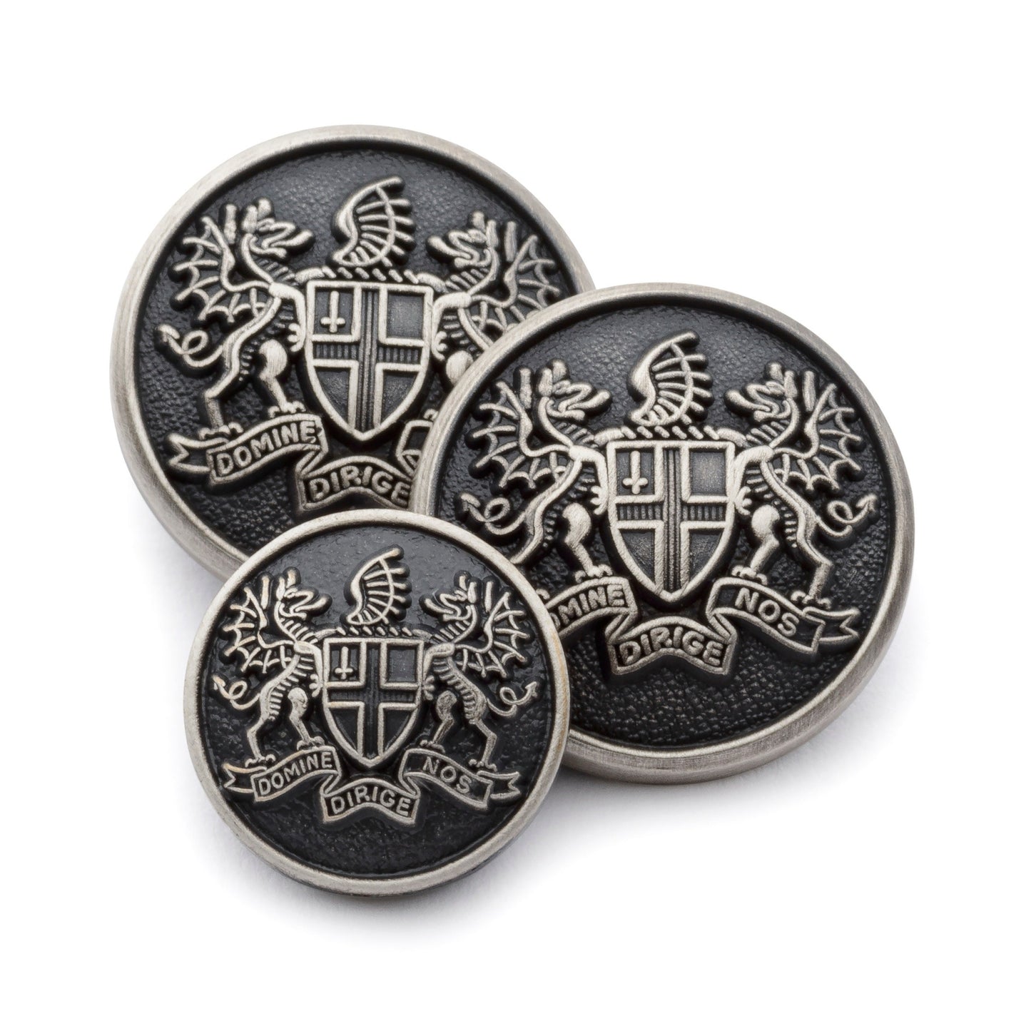 Antique silver blazer button set with detailed engraving, displayed on a dark background by Benson & Clegg.