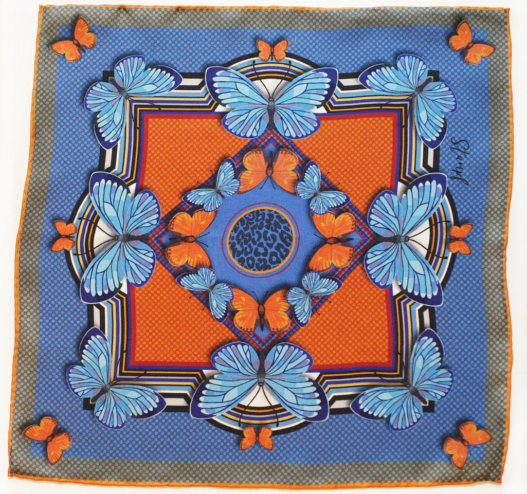 A vibrant butterfly and blaze pattern pocket square in bold red and gold tones by Benson & Clegg.