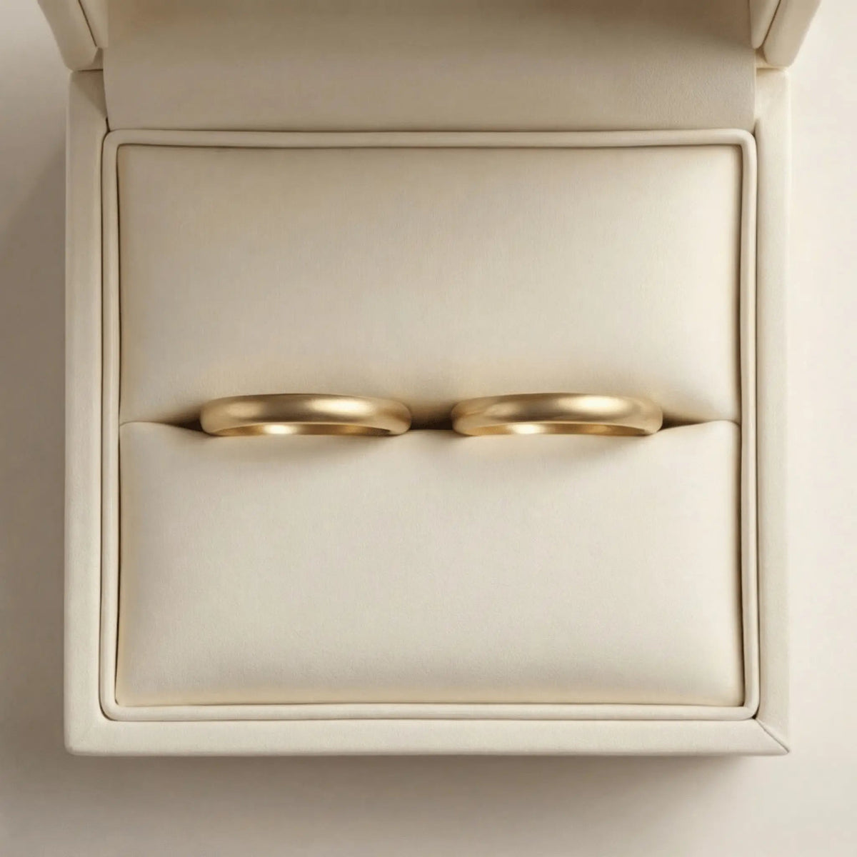A slim gold wedding band set featuring a 2mm width in 9ct, 14ct, and 18ct gold by Majestic Jewellery.