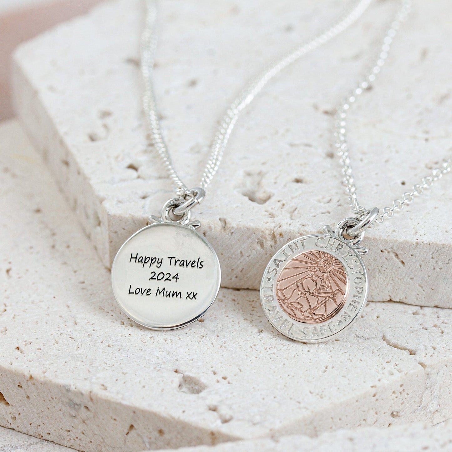 A silver and rose gold St Christopher necklace with personalized engraving, displayed on a soft white background by Scarlett 