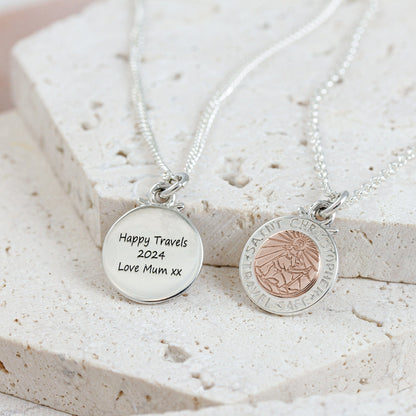 A silver and rose gold St Christopher necklace with personalized engraving, displayed on a soft white background by Scarlett 