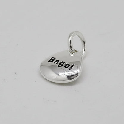 Silver pet paw print charm with personalized engraving by Scarlett Jewellery.