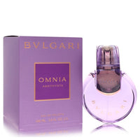 Bvlgari Omnia Amethyste perfume bottle in deep purple glass with gold details, standing on a white surface by The Fragrance A