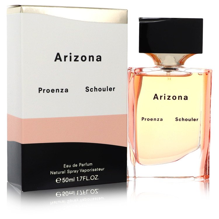 Blue glass bottle with gold accents resting on a white surface, labeled Proenza Schouler Arizona Eau de Parfum Spray for Wome