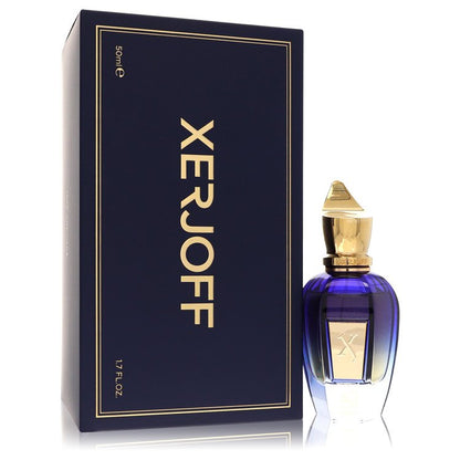 A clear glass bottle with a black cap and gold label labeled 40 Knots by Xerjoff, standing on a wooden surface.
