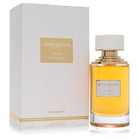A golden perfume bottle with intricate design on a white background, labeled Boucheron Ambre d'Alexandrie Eau de Parfum Spray