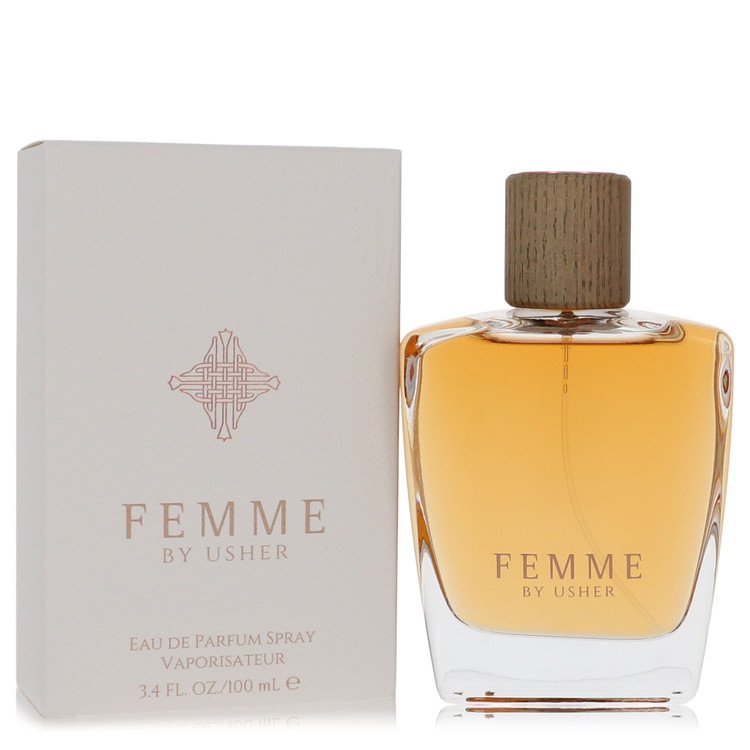 A clear glass perfume bottle with a pink cap and gold accents, labeled Usher Femme by Usher, displayed on a white background.