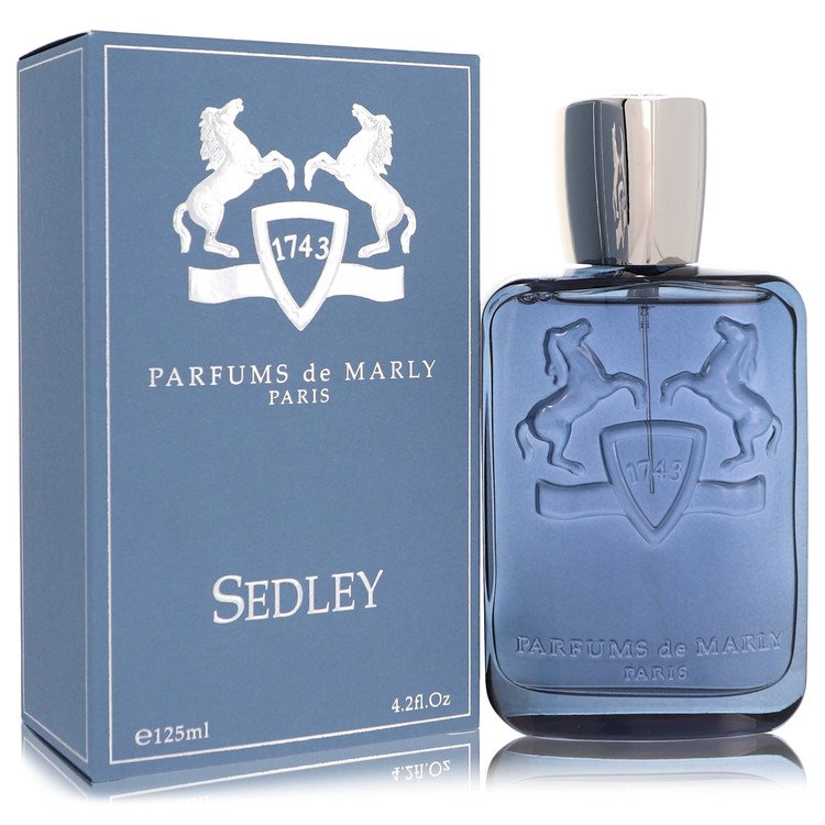 A clear glass bottle with gold accents and a black cap, labeled Sedley Eau De Parfum Spray by Parfums De Marly, standing on a