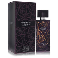 Lalique Amethyst Exquise eau de parfum spray in clear glass bottle with gold accents, displayed on a white surface by The Fra