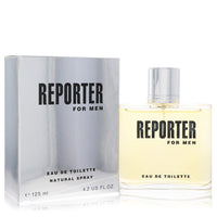 Blue glass bottle with silver cap, standing on a wooden surface, labeled Reporter Eau De Toilette Spray for Men, 4.2 oz / 125