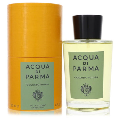 A clear glass bottle with a gold cap and blue label, standing on a white surface, labeled "Colonia Futura" by The Fragrance A