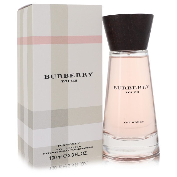 Burberry Touch Eau de Parfum Spray in gold bottle with black cap, standing on a white surface by The Fragrance Avenue.