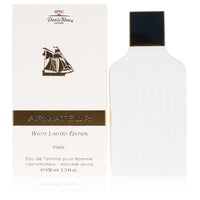 A white eau de toilette spray bottle with a blue label and gold accents, standing on a wooden surface, by The Fragrance Avenu