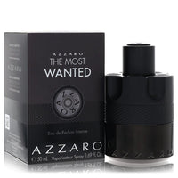 Azzaro The Most Wanted Eau De Parfum Intense spray bottle in black glass with gold accents on a wooden surface by The Fragran