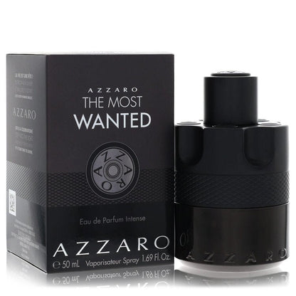 Azzaro The Most Wanted Eau De Parfum Intense spray bottle in black glass with gold accents on a wooden surface by The Fragran
