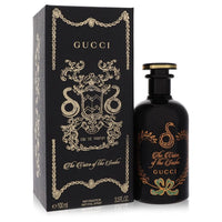 Gucci The Voice of the Snake Eau de Parfum Spray in gold bottle with snake motif on white background by The Fragrance Avenue.