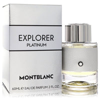 Blue glass bottle with platinum cap and black label featuring the Montblanc logo, standing on a wooden surface, 2 oz (60 ml) 