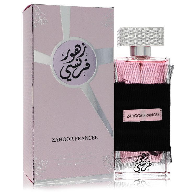 A clear glass bottle with gold accents and a black cap, labeled Al Zaafaran Zahoor Francee, standing on a white surface by Th