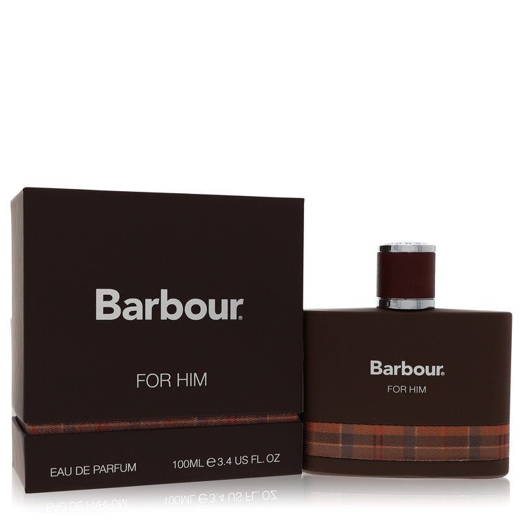 A blue glass bottle with a black cap and white label, featuring the Barbour Origins logo, displayed on a wooden surface by Th