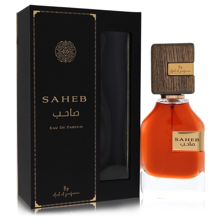 A clear glass bottle with gold accents and a minimalist label, featuring the text "Al Zaafaran Saheb" in black, displayed on 