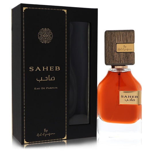 A clear glass bottle with gold accents and a minimalist label, featuring the text "Al Zaafaran Saheb" in black, displayed on 