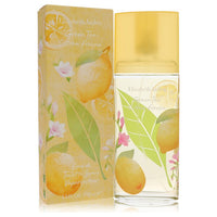 A clear glass bottle with green tea and citron fragrance, standing on a wooden surface, labeled "Elizabeth Arden" by The Frag