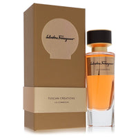 Blue glass bottle of Salvatore Ferragamo La Commedia Unisex Eau de Parfum Spray 3.3 oz / 100 ml with minimalist design by The