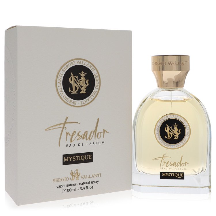 A clear glass bottle with a gold cap and black label, labeled "Dumont Tresador Mystique" on a white background by The Fragran
