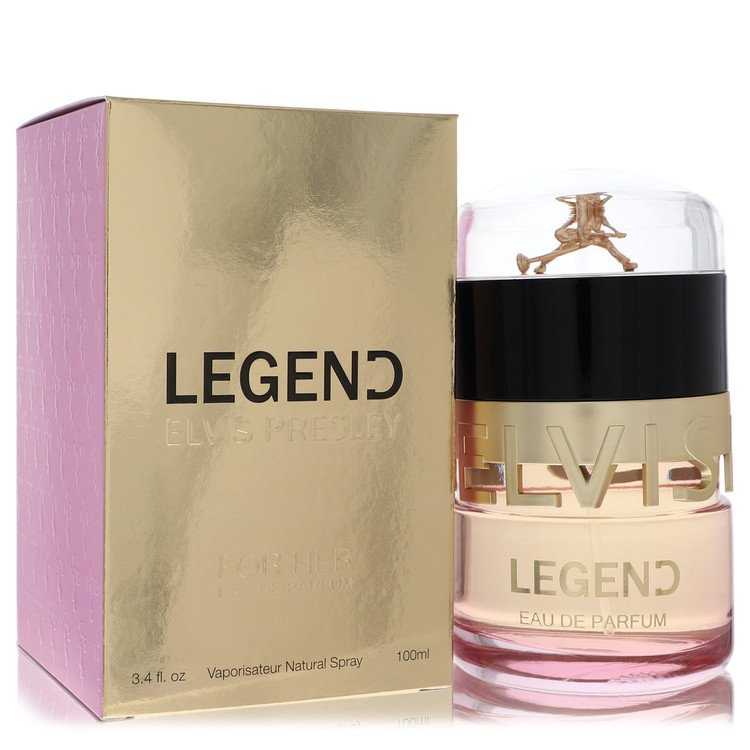 A golden bottle of Elvis Presley Legend Eau de Parfum Spray with a black label and white text, standing on a wooden surface b