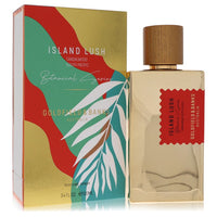 A clear glass perfume bottle with a gold label and green accents, displayed on a wooden surface, by The Fragrance Avenue.