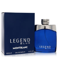 Blue glass bottle with silver cap, standing on a wooden surface, labeled Montblanc Legend Blue Eau de Parfum Spray 3.3 oz / 1