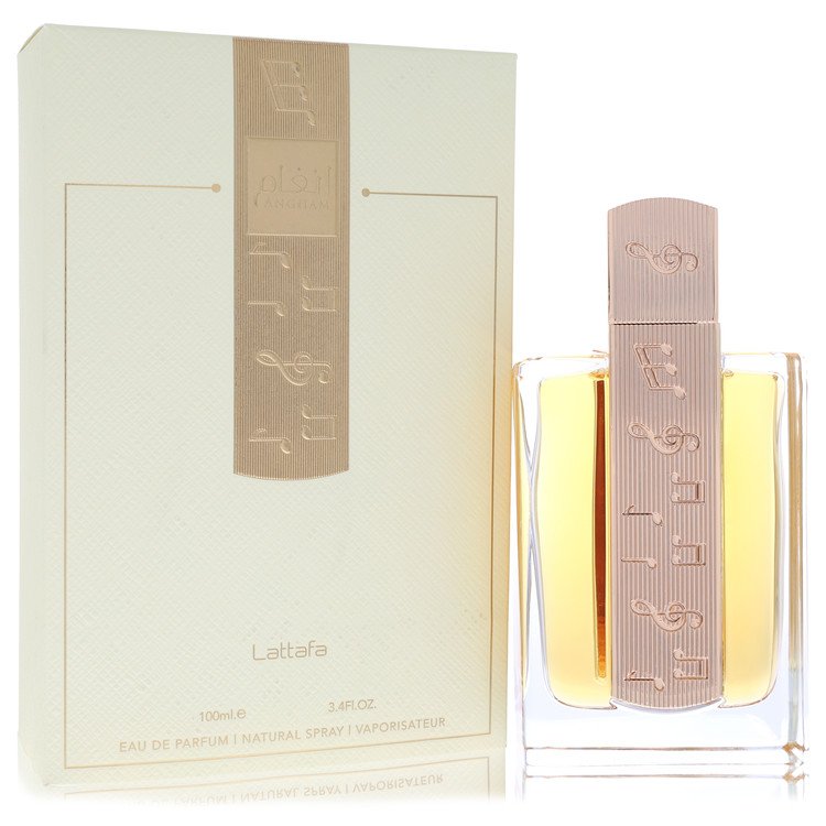 A clear glass bottle with gold accents and a black cap, labeled Lattafa Angham, standing on a white surface by The Fragrance 