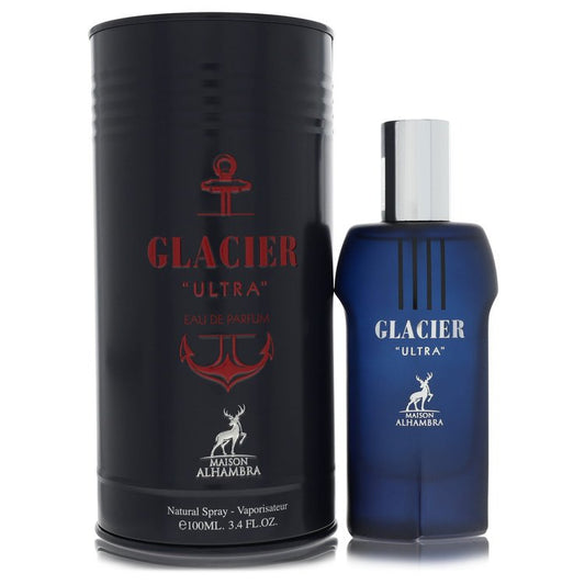 A blue glass bottle with a silver cap, standing on a wooden surface, labeled "Maison Alhambra Glacier Ultra" by The Fragrance