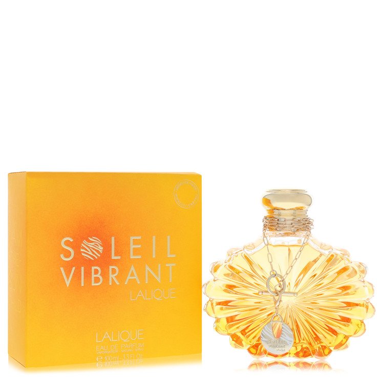 Lalique Soleil Vibrant eau de parfum spray in gold bottle with sun motif on white background by The Fragrance Avenue.