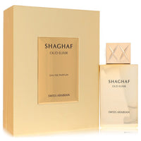 A clear glass bottle of Swiss Arabian Shaghaf Oud Elixir Eau De Parfum Spray with a golden cap and dark amber liquid, standin