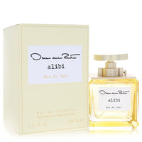 Blue glass bottle with gold accents sitting on a white surface, featuring the Oscar De La Renta logo, 3.4 oz eau de toilette 