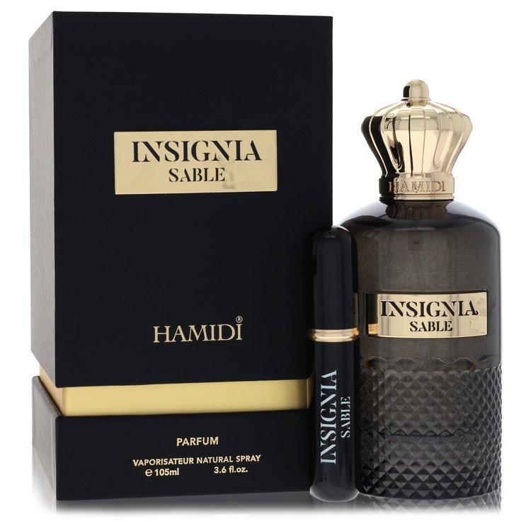 Blue glass perfume bottle with gold label and black cap, standing on a wooden surface, labeled Hamidi Insignia Sable for Men 