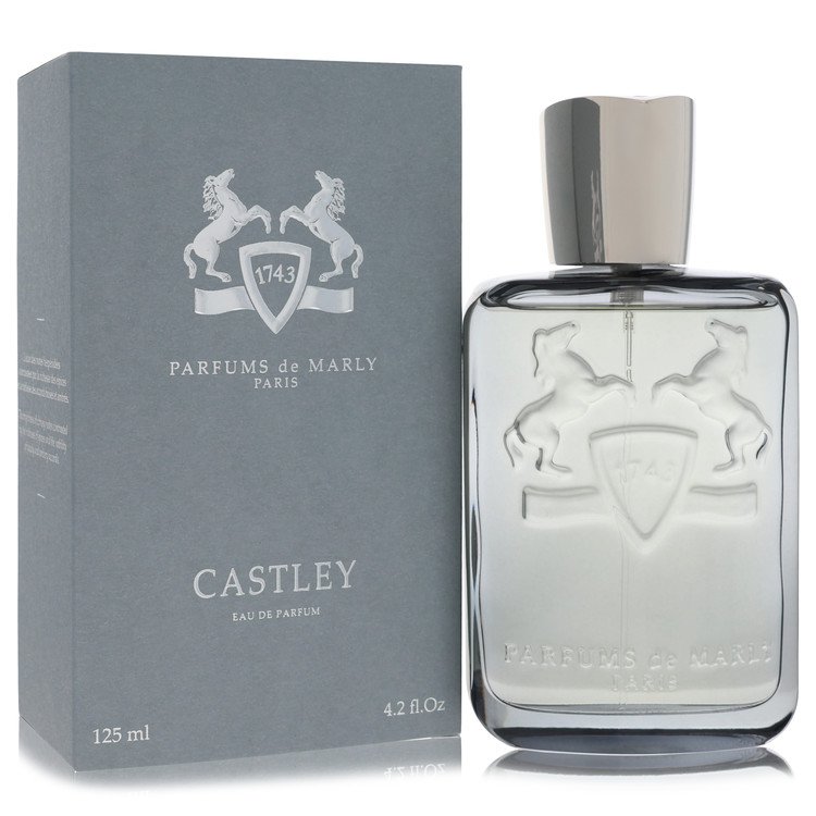 Blue glass bottle with gold accents sitting on a wooden surface, featuring a minimalist label and logo, Castley Eau De Parfum