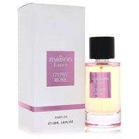 A pink glass perfume bottle with gold accents and a rose design, standing on a white surface, labeled Hamidi Maison Luxe Gyps