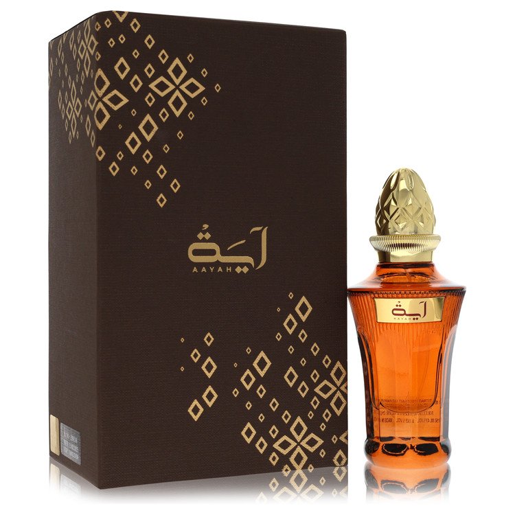 A deep blue glass bottle with gold lettering and a minimalist design, standing on a white surface, labeled "Ahmed Al Maghribi