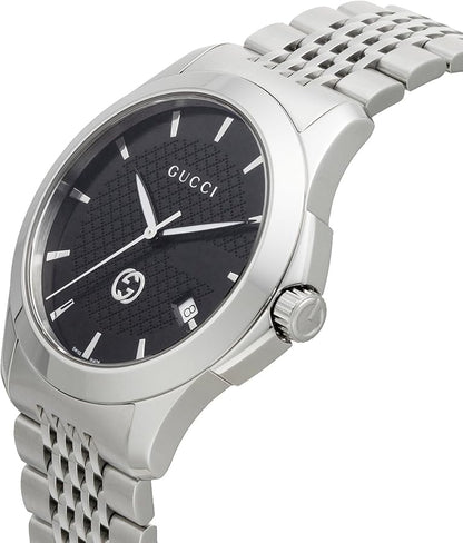 Silver dial with black Roman numerals on a stainless steel watch face, featuring a leather strap and Gucci logo at 12 o'clock