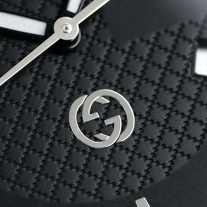 Black leather watch with silver dial and Gucci logo, 38mm case, worn on a wrist.