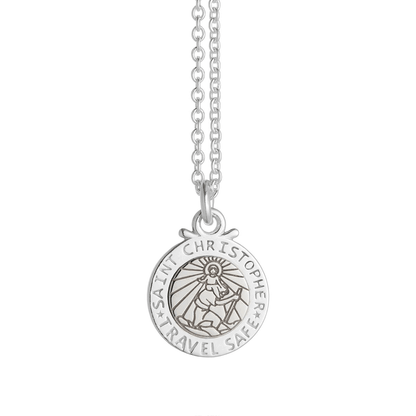 Silver St Christopher pendant on a chain with personalized engraving, styled on a wooden background by Scarlett Jewellery.