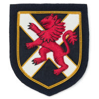 A brass Scottish lion blazer badge with a black background, featuring the Benson & Clegg logo.
