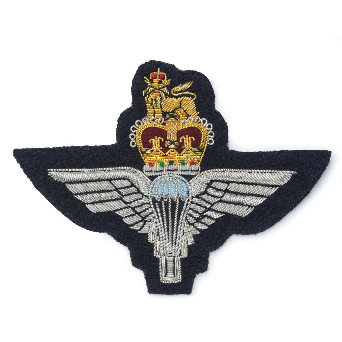 A brass blazer badge featuring the Parachute Regiment emblem, mounted on a dark blue background, by Benson & Clegg.