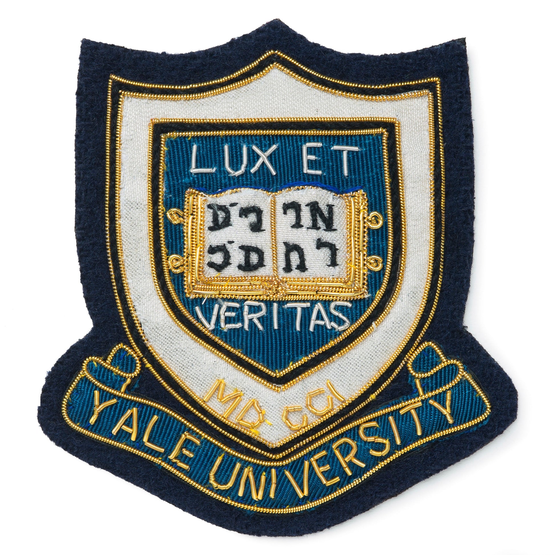 Blue blazer badge with Yale University crest on a dark blue background by Benson & Clegg.